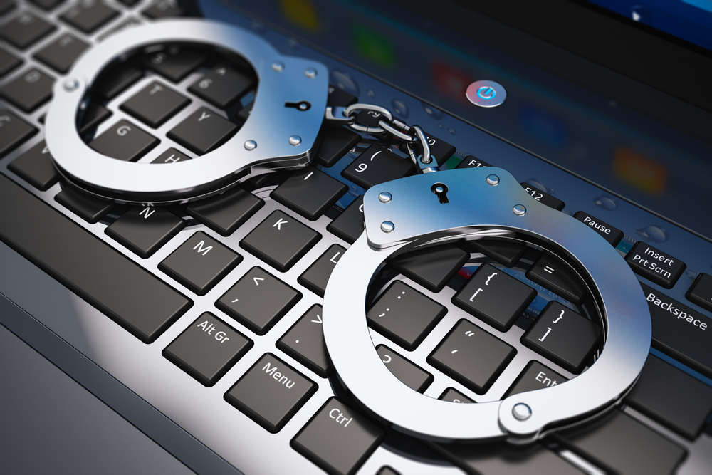 police handcuff security crime keyboard © Oleksiy Mark Shutterstock